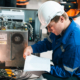 Repair Specialist Inspects Machinery In Factory Ensuring Industry Standards With Spare Parts